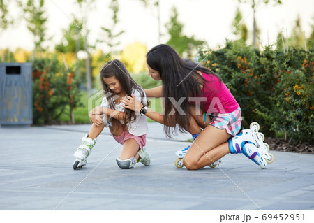 little child girl falled down while rolling with her mother 69452951