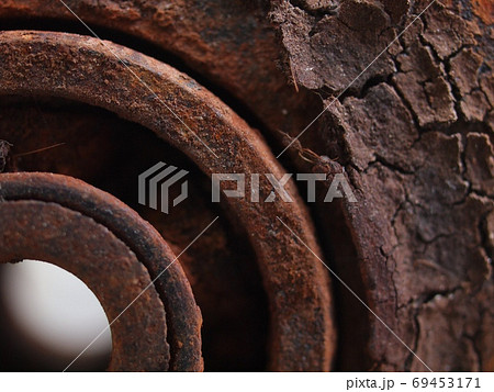 rustic weathered large roller with ball bearing disassembly from worn out factory slide door after flood show dried out grease and broken bearing hard rustic iron oxide surface need replacement 69453171
