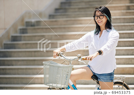 Chinese woman sitting on bicycle 69453375