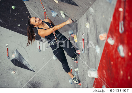 sporty woman in boulder climbing hall 69453407