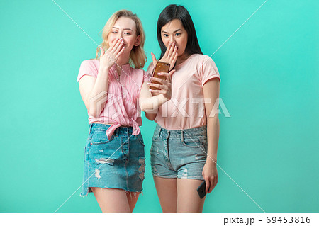 two multiethnic beautiful women asian and caucasian taking selfie at studio two multiethnic beautiful women asian and caucasian taking selfie at studio 69453816