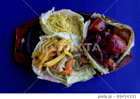 fried rise and potatoes with vegetables and fish 69454101