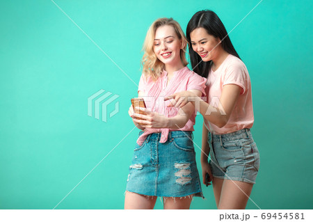 two multiethnic beautiful women asian and caucasian taking selfie at studio two multiethnic beautiful women asian and caucasian taking selfie at studio 69454581