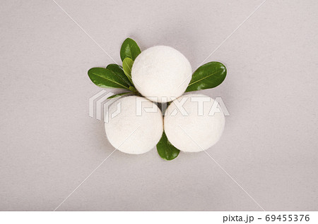 Wool Dryer Balls on a gray background. Eco friendly laundry supplies. Reusable non-toxic wool balls 69455376
