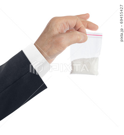 Hand and packet with narcotic 69455427
