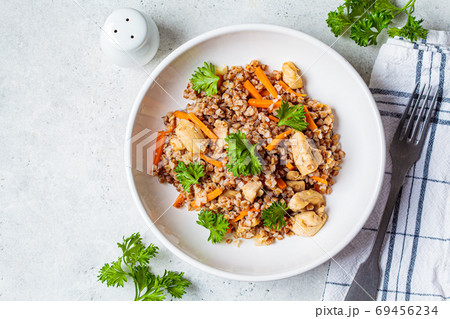 Buckwheat with chicken meat and vegetables in a white plate 69456234