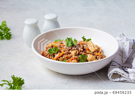 Buckwheat with chicken meat and vegetables in a white plate Buckwheat with chicken meat and vegetables in a white plate 69456235