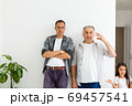 Senior father with adult son talking, isolated white background. 69457541
