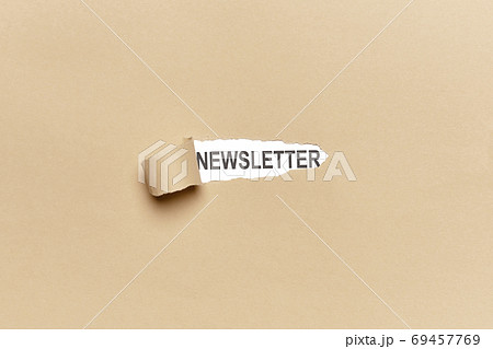 Broken brown wrapping paper with the word NEWSLETTER appearing 69457769