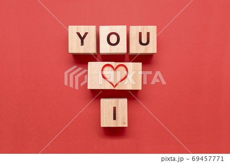 Wooden dice with a heart and the words I and YOU on a red background 69457771