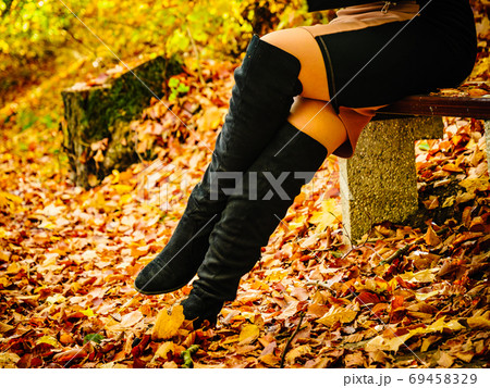 Woman wearing black knee high boots 69458329