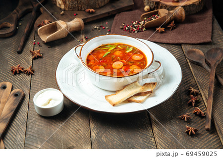 Hot sausage tomato soup in a white bowl 69459025
