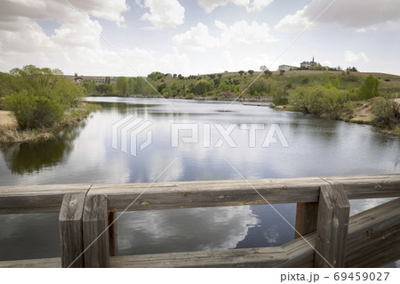 Old wooden bridge rises a river on a quiet and lonely cloudy day 69459027