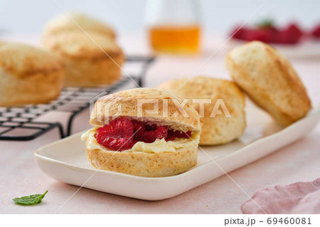Traditional British Scones with clotted cream, raspberry jam. Scones with raspberry jam Traditional British Scones with clotted cream, raspberry jam. Scones with raspberry jam 69460081