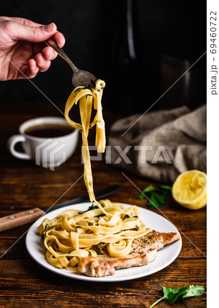 Pork chop steak with tagliatelle and capers Pork chop steak with tagliatelle and capers 69460722