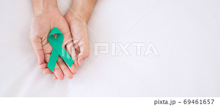 September Ovarian cancer Awareness month, Woman holding teal Rib September Ovarian cancer Awareness month, Woman holding teal Rib 69461657