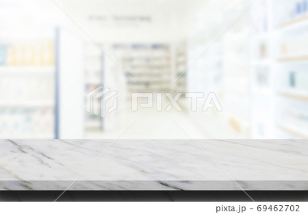 Marble stone table top grunge texture background with blurry image inside of pharmacy or drugstore in background. Marble stone table top grunge texture background with blurry image inside of pharmacy or drugstore in background. 69462702