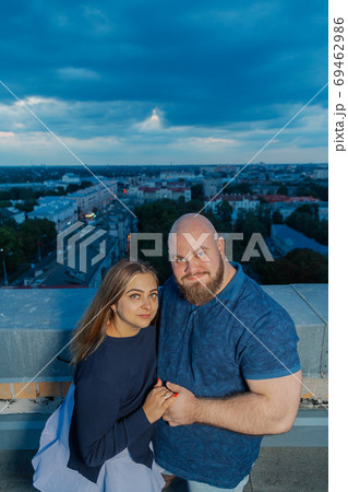 Beautiful and happy lovers on the roof hugging. 69462986