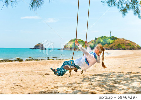 Woman on beach swing 69464297