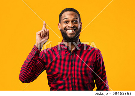 Excited black man having great idea and pointing up Excited black man having great idea and pointing up 69465363