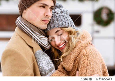 Young Affectionate Couple Enjoying Winter Day Together, Hugging And Bonding Outdoors 69465584