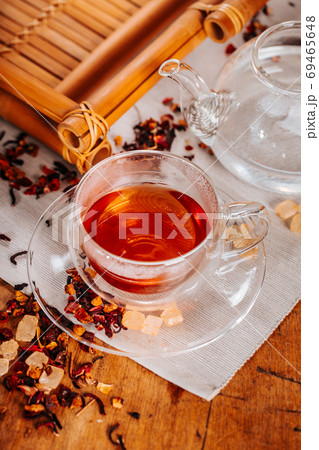 Cup of hot tea with rock sugar, dry tea leaves served in thermo glass tea cup 69465648
