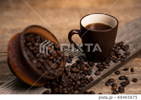 Coffee and coffee beans on old rustic wood table 69465675