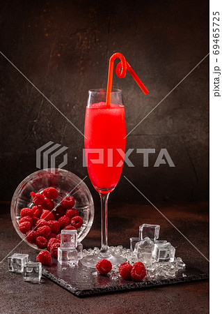 Delicious cold refreshing smoothie drink in cocktail glass with raspberry 69465725
