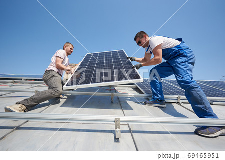 Installing solar photovoltaic panel system on roof of house 69465951