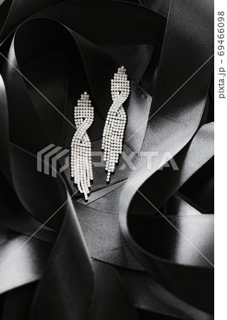 Luxury diamond earrings on black silk ribbon as background, jewelry and fashion brand Luxury diamond earrings on black silk ribbon as background, jewelry and fashion brand 69466098