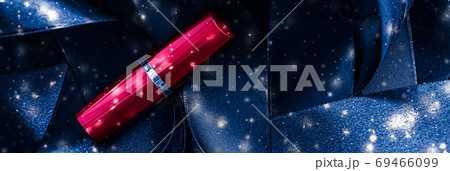 Red lipstick on blue silk and shiny glitter background, luxury make-up and beauty cosmetic Red lipstick on blue silk and shiny glitter background, luxury make-up and beauty cosmetic 69466099