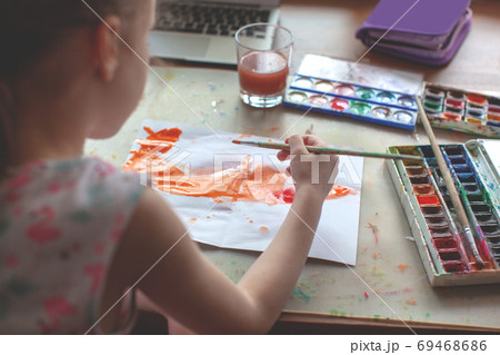 7 years old girl draws with watercolors. Close-up.  69468686