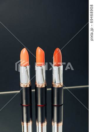 Lipstick in different colors on a dark background Lipstick in different colors on a dark background 69468908