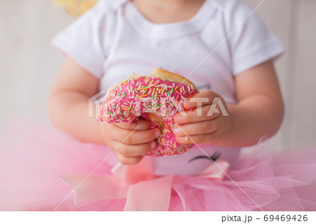 One year old baby girl celebrates her birthday. Close up. One year old baby girl celebrates her birthday. Close up. 69469426