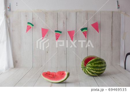 Photo zone with watermelon and garland. Photo zone with watermelon and garland. 69469535