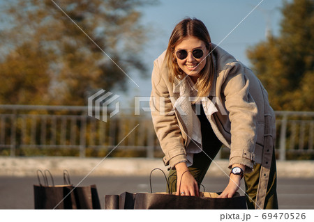 Young woman with shopping bags on parking 69470526