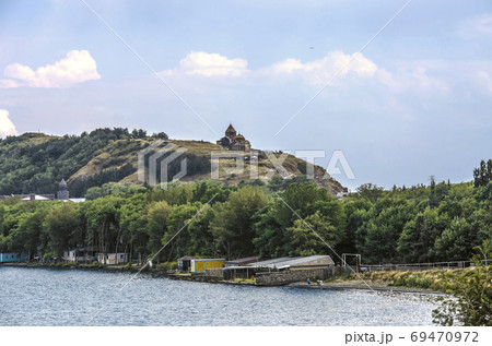 Peninsula on lake Sevan, and a hill with a medieval monastery of St. Apostles of the 9th century in the Gegharkunik region of Armenia 69470972