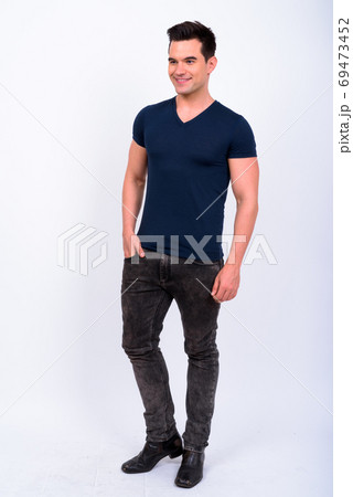 Full body shot of happy young handsome man thinking Full body shot of happy young handsome man thinking 69473452