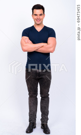 Full body shot of happy young handsome man smiling with arms crossed Full body shot of happy young handsome man smiling with arms crossed 69473455