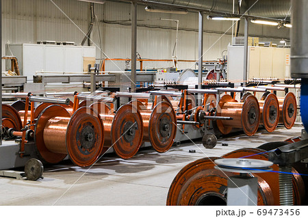 Production of copper wire, bronze cable in reels at factory Production of copper wire, bronze cable in reels at factory 69473456