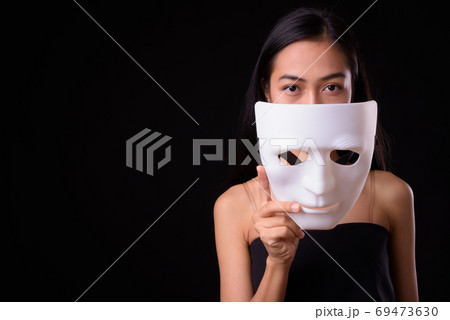 Face of young beautiful Asian woman with mask Face of young beautiful Asian woman with mask 69473630