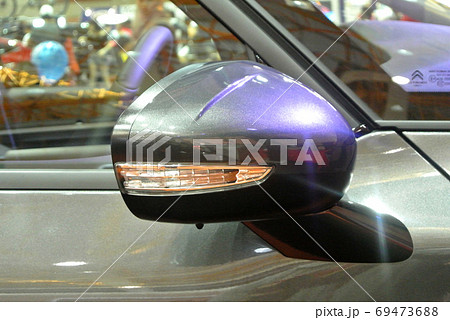 KUALA LUMPUR, MALAYSIA -NOVEMBER 12, 2017: Car side mirror or door mirror build at extrior of car for the purposes of helping the driver see areas behind and to the sides of the vehicle. KUALA LUMPUR, MALAYSIA -NOVEMBER 12, 2017: Car side mirror or door mirror build at extrior of car for the purposes of helping the driver see areas behind and to the sides of the vehicle. 69473688