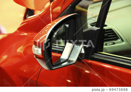 KUALA LUMPUR, MALAYSIA -NOVEMBER 12, 2017: Car side mirror or door mirror build at extrior of car for the purposes of helping the driver see areas behind and to the sides of the vehicle. KUALA LUMPUR, MALAYSIA -NOVEMBER 12, 2017: Car side mirror or door mirror build at extrior of car for the purposes of helping the driver see areas behind and to the sides of the vehicle. 69473698