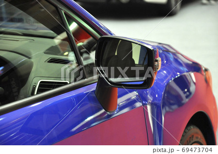 KUALA LUMPUR, MALAYSIA -NOVEMBER 12, 2017: Car side mirror or door mirror build at extrior of car for the purposes of helping the driver see areas behind and to the sides of the vehicle. KUALA LUMPUR, MALAYSIA -NOVEMBER 12, 2017: Car side mirror or door mirror build at extrior of car for the purposes of helping the driver see areas behind and to the sides of the vehicle. 69473704