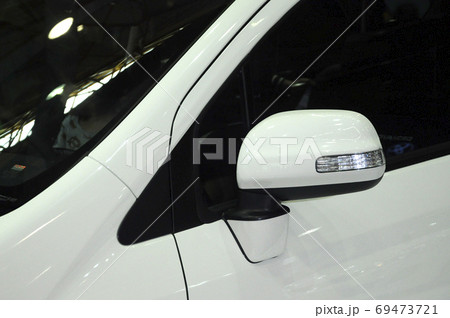 KUALA LUMPUR, MALAYSIA -NOVEMBER 12, 2017: Car side mirror or door mirror build at extrior of car for the purposes of helping the driver see areas behind and to the sides of the vehicle. KUALA LUMPUR, MALAYSIA -NOVEMBER 12, 2017: Car side mirror or door mirror build at extrior of car for the purposes of helping the driver see areas behind and to the sides of the vehicle. 69473721