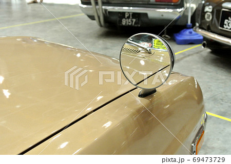 KUALA LUMPUR, MALAYSIA -NOVEMBER 12, 2017: Car side mirror or door mirror build at extrior of car for the purposes of helping the driver see areas behind and to the sides of the vehicle. KUALA LUMPUR, MALAYSIA -NOVEMBER 12, 2017: Car side mirror or door mirror build at extrior of car for the purposes of helping the driver see areas behind and to the sides of the vehicle. 69473729