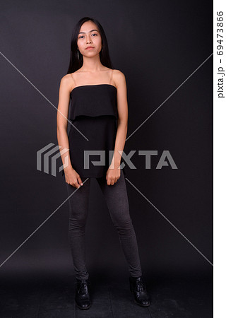 Full body shot of young beautiful Asian woman 69473866