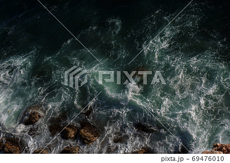 Ocean wave background breaking sea water rocky shore 69476010