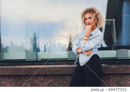 pretty young woman in casual clothes inside trade centre background. pretty young woman in casual clothes inside trade centre background. 69477152