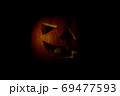 jack o lantern big orange pumpkin on a black background in low key 69477593